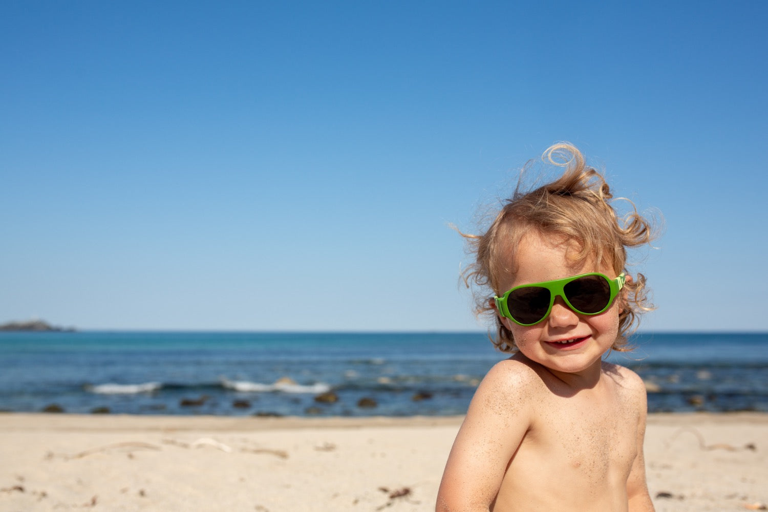A boy wearing green sunglasses from Mokki