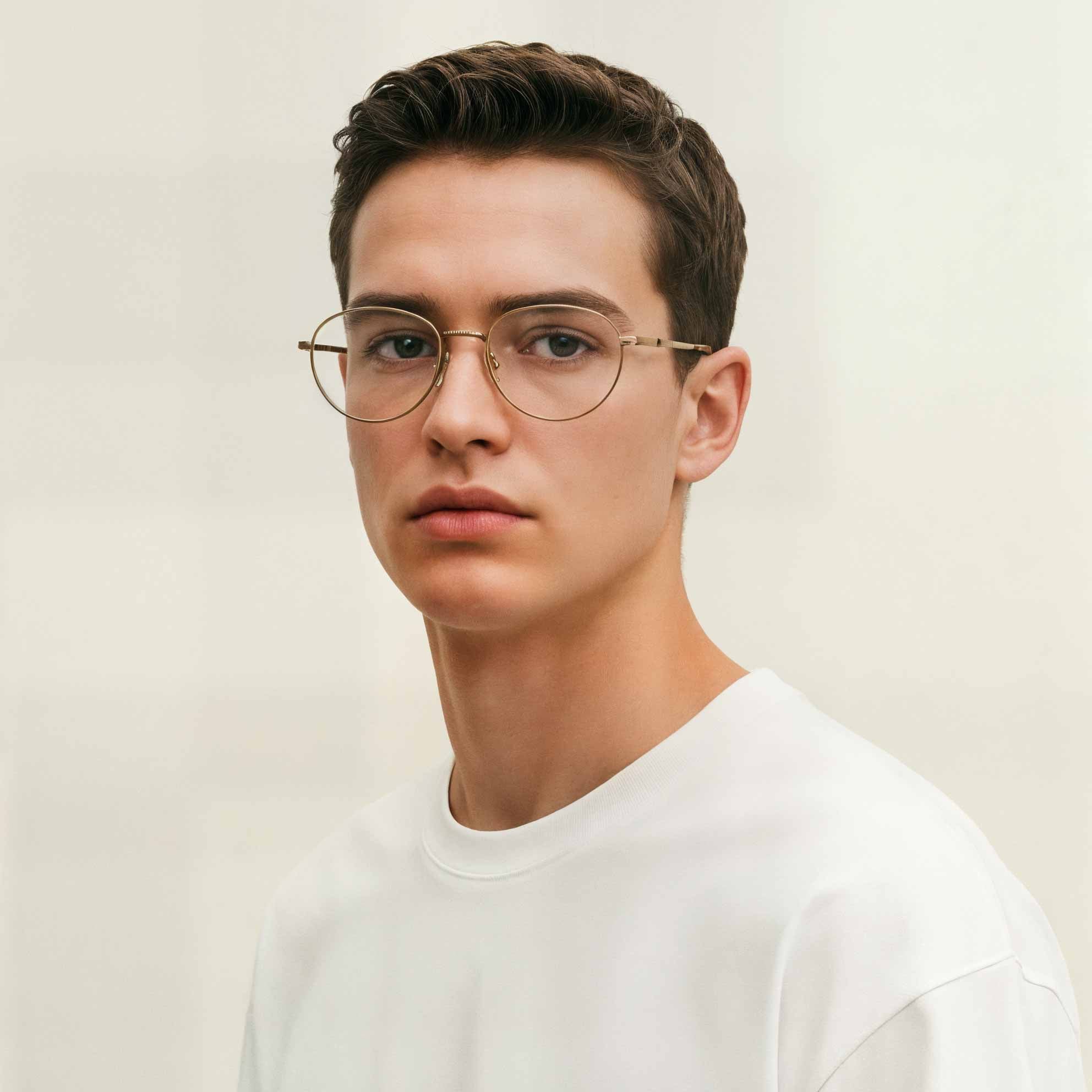 Man wearing Mokki reading glasses and a white shirt against a plain background