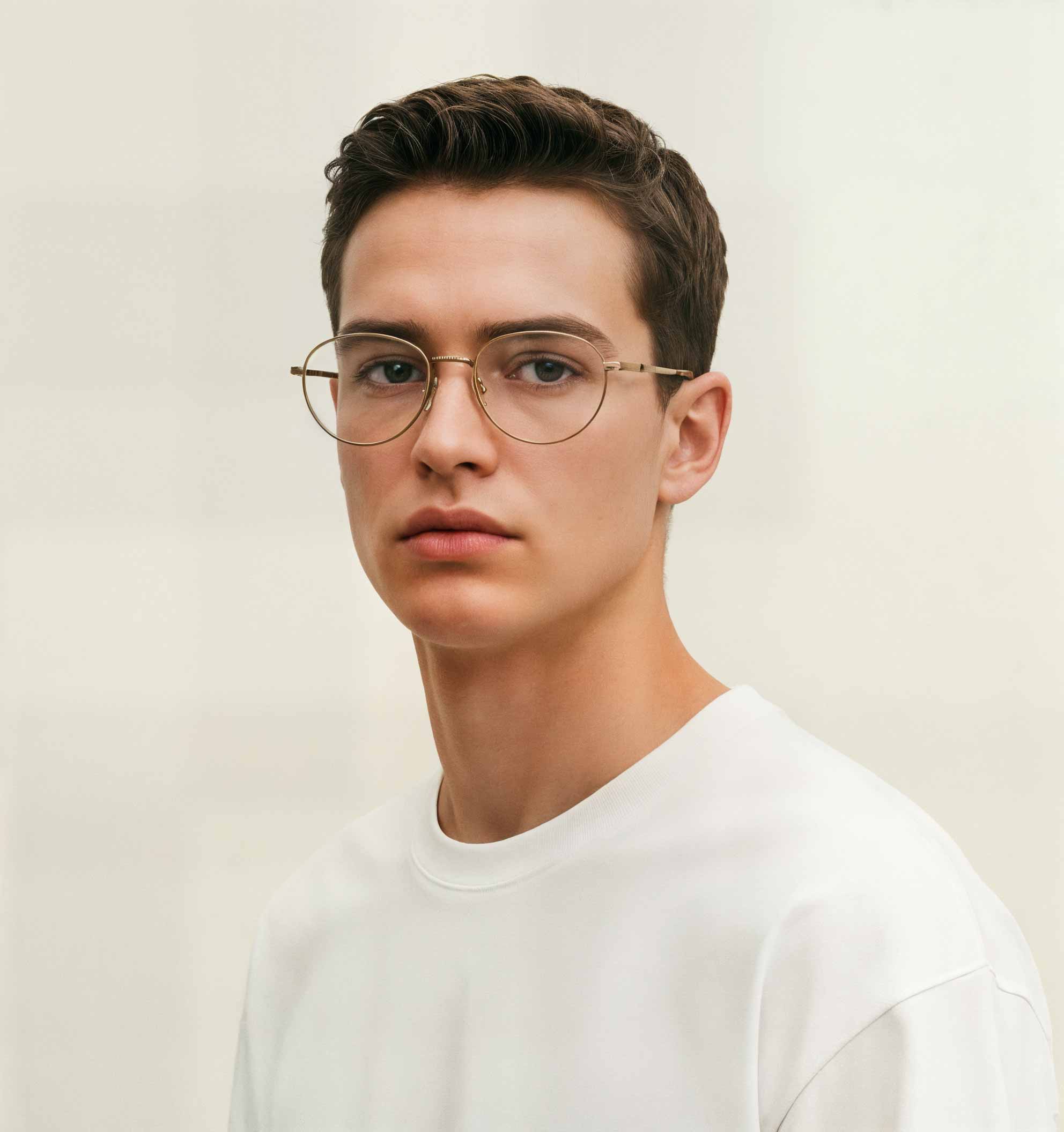 Man wearing Mokki reading glasses and a white shirt against a plain background