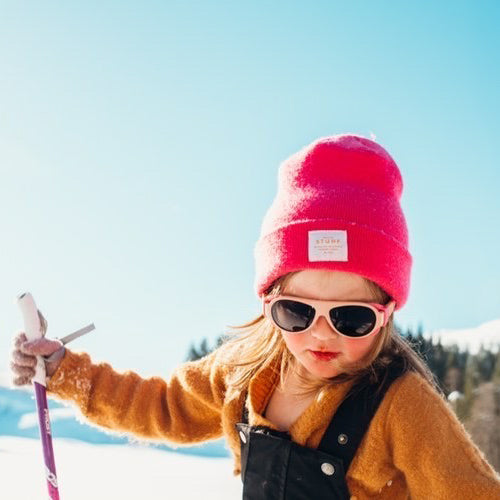 Girl wearing mokki sunglasses for kids while skiing