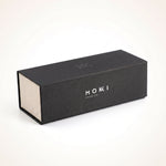 A rectangular protective hard case for sunglasses with a textured finish, featuring the brand name 'MOKKI PREMIUM', set against a clean white background.