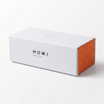 A white rectangular sunglasses hard case, featuring the brand name 'MOKKI MOTION' printed on the front, set against a clean white background.