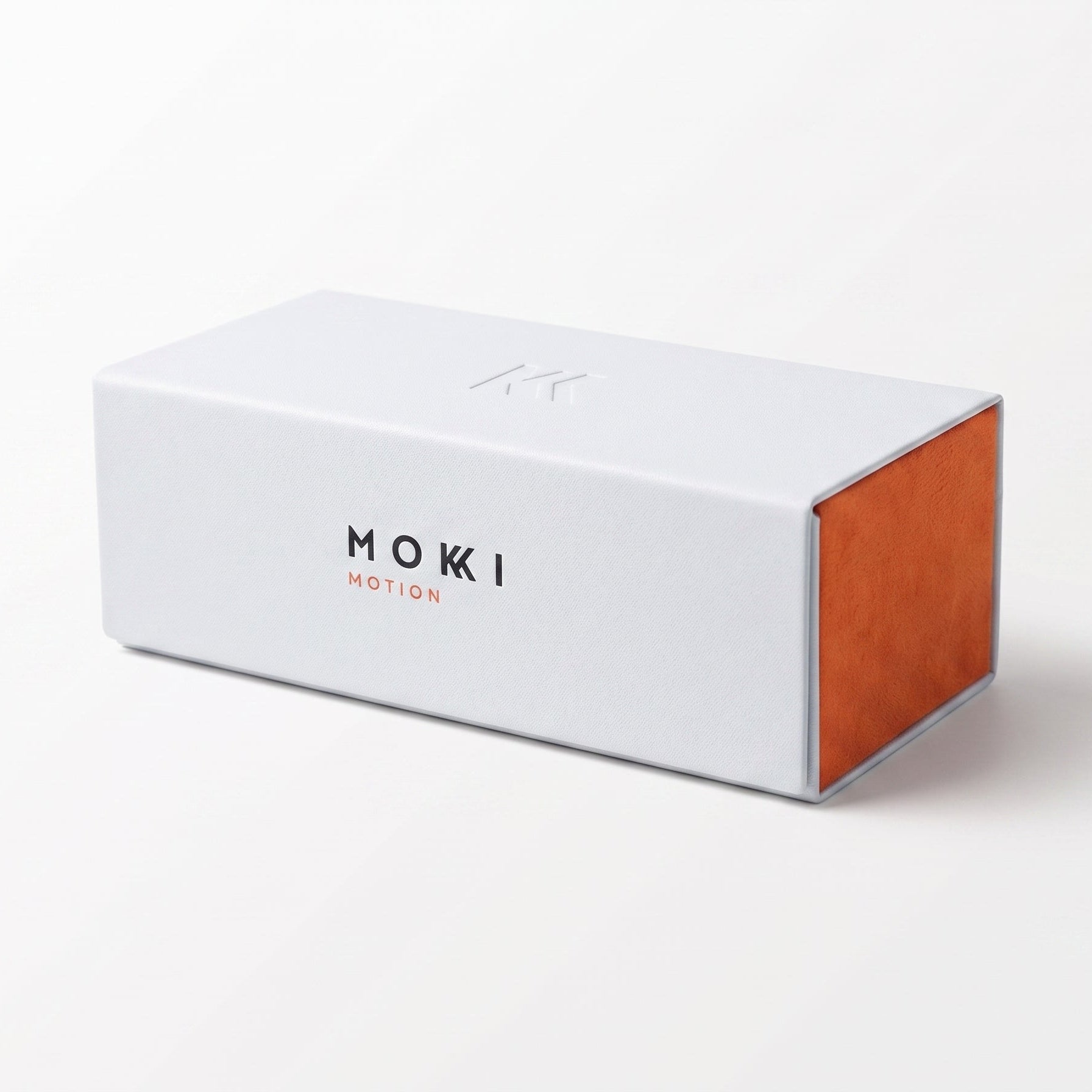 A white rectangular sunglasses hard case, featuring the brand name 'MOKKI MOTION' printed on the front, set against a clean white background.