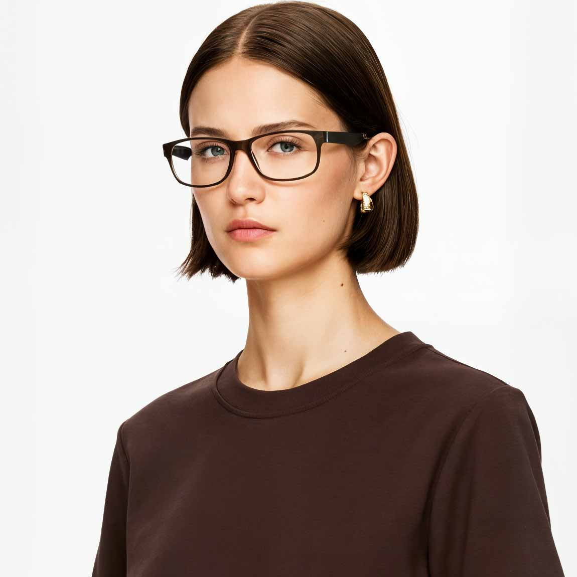Woman wearing black Mokki glasses and a brown shirt on a white background