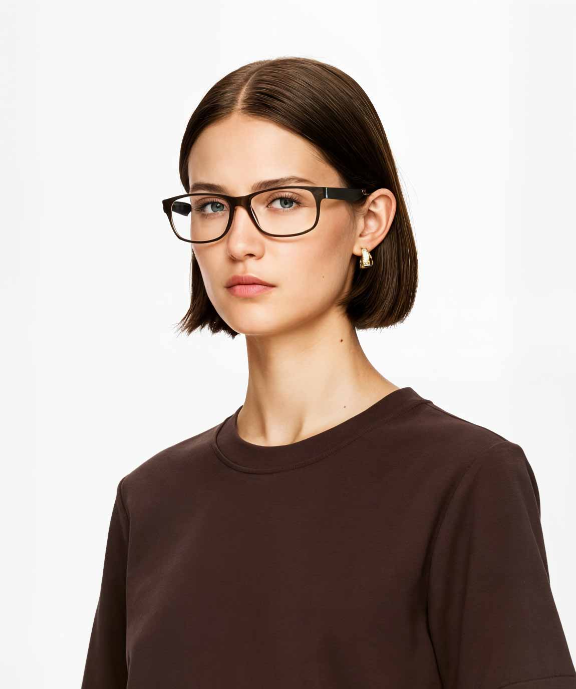 Woman wearing black Mokki glasses and a brown shirt on a white background