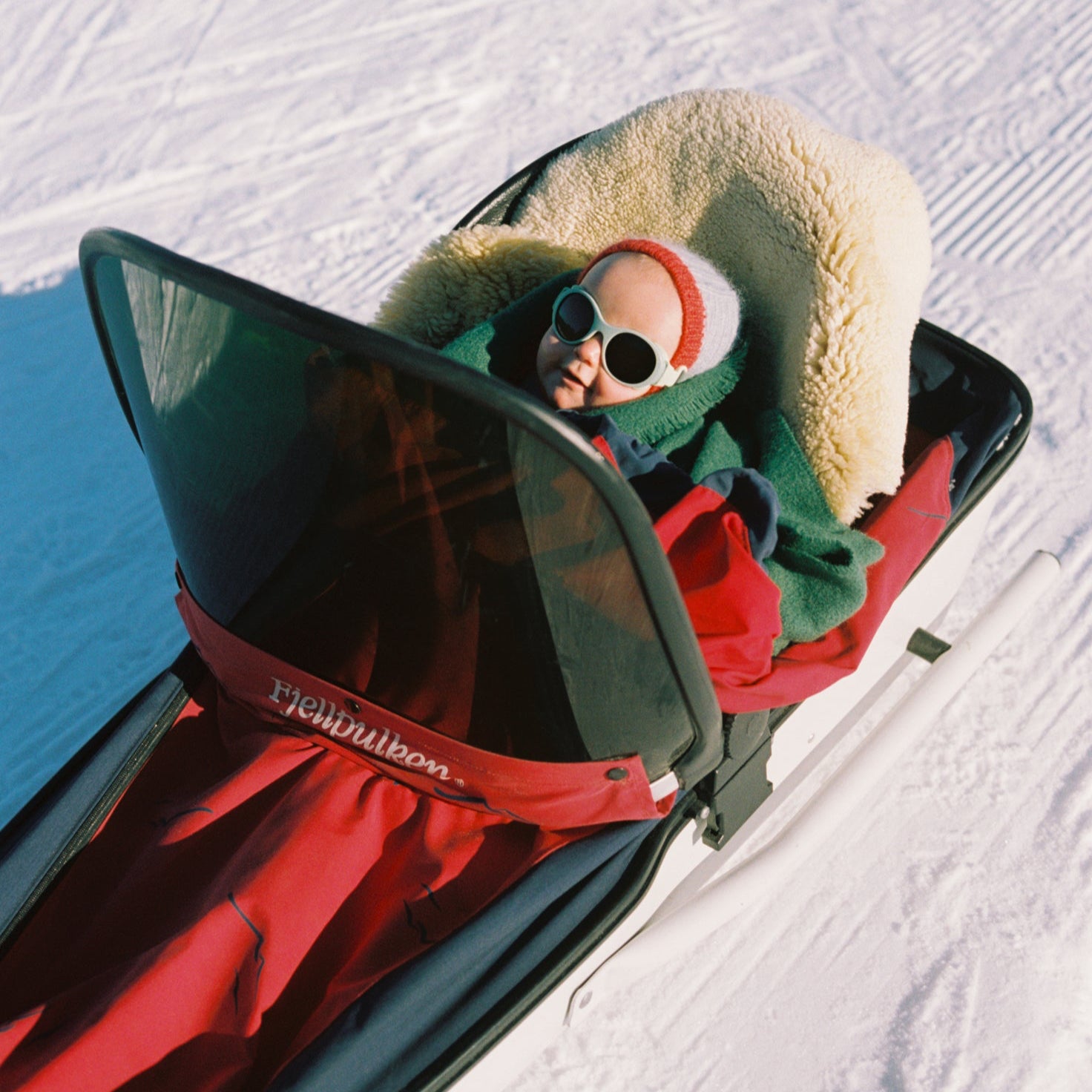 Boy wearing grey Click & Change polarised sunglasses from Mokki in a snowy landscape
