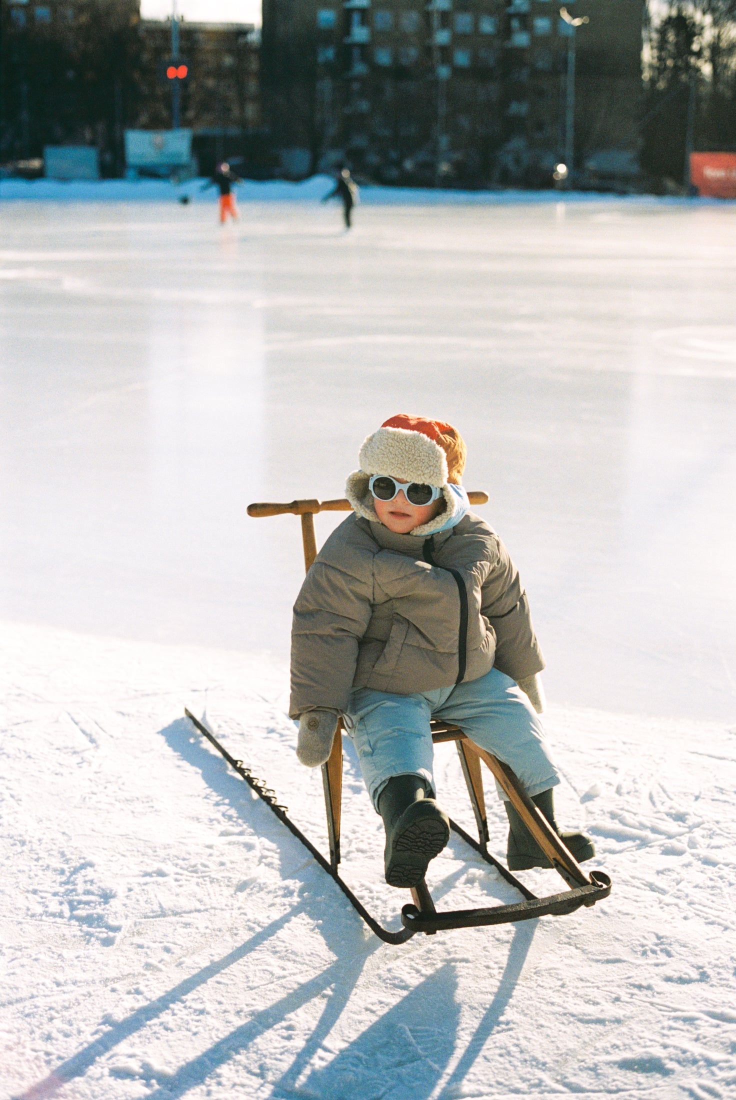 Young boy ice skating with Mokki Click & Change sunglasses