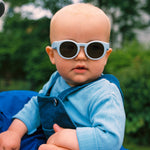 Baby wearing blue Mokki Click & Change sunglasses in 0-1