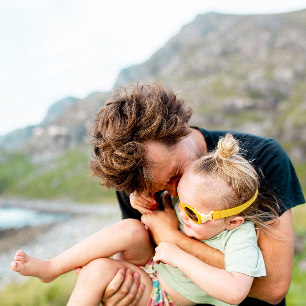 Father hugging his daughter that is wearing yellow Click & Change sunglasses