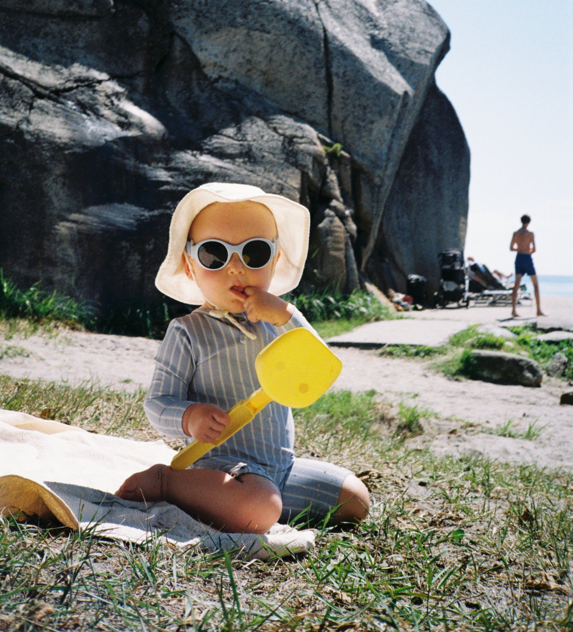 1 year old boy wearing Mokki Click & Change sunglasses on the beach