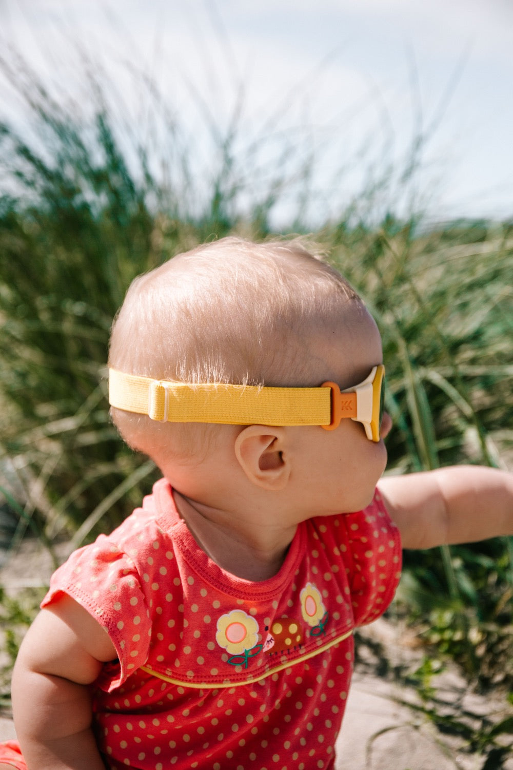 Baby uses Click & Change sunglasses with a headband.
