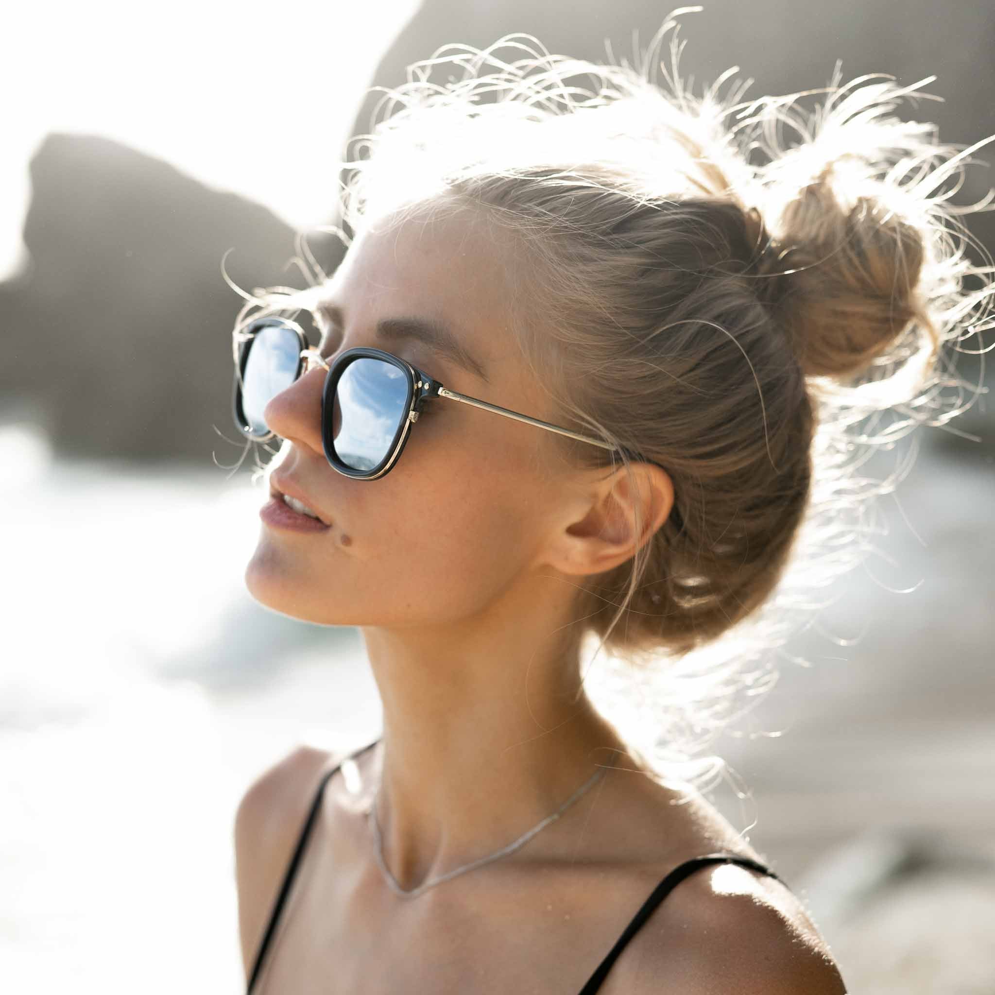 Woman wearing Mokki sunglasses in gold