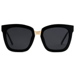 A pair of oversized black cat-eye sunglasses with gold accents on the arms.
